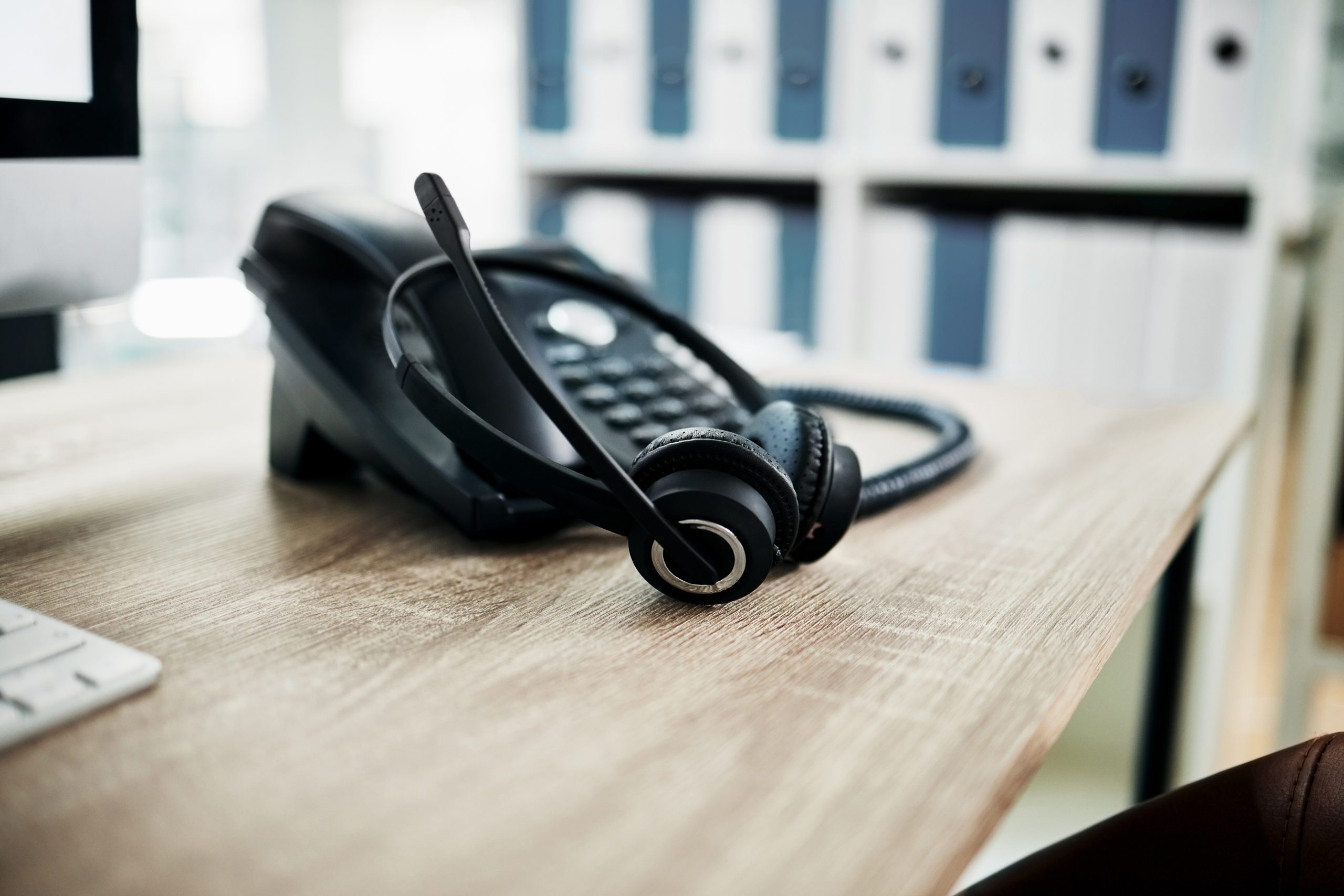 Telephone, contact us with call center, communication and headphone with microphone on work desk. C.